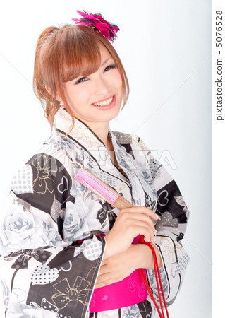 A girl with a nice yukata looking with a happy smile A girl with a nice yukata looking with a happy smile 5076528
