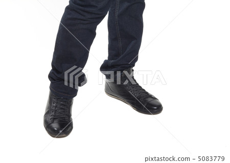 Man's feet in blue trousers and black shoes Man's feet in blue trousers and black shoes 5083779