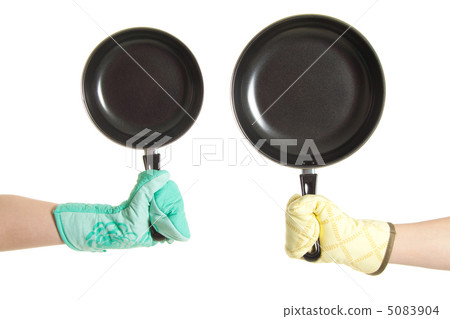 two hands in gloves holding pan's 5083904