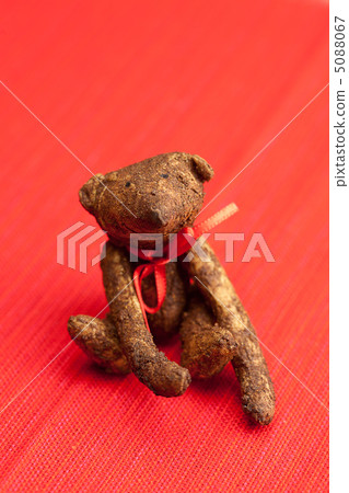 Teddy bear handmade on a red background Teddy bear handmade on a red background 5088067