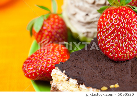 cake and strawberries lying on the orange fabric cake and strawberries lying on the orange fabric 5090520