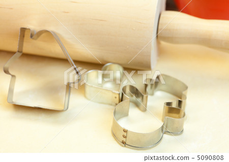 forms for the cookies, rolling pin and dough forms for the cookies, rolling pin and dough 5090808