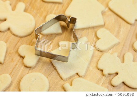 cut dough snowman, house, heart, and forms for cookies 5091098
