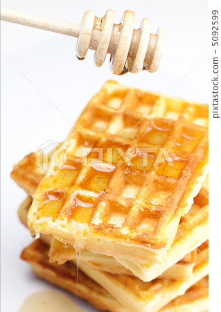 delicious Belgian waffles and stick to honey isolated on white 5092599
