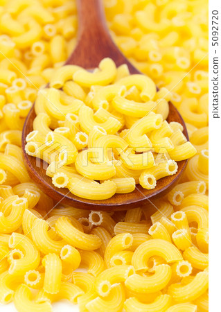 background of pasta and a wooden spoon background of pasta and a wooden spoon 5092720