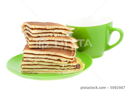 Pancakes on a plate and cup isolated on white Pancakes on a plate and cup isolated on white 5092987