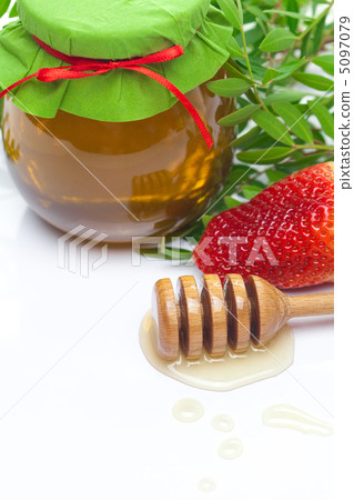 stick to hohey and  jar of honey  isolated on white 5097079