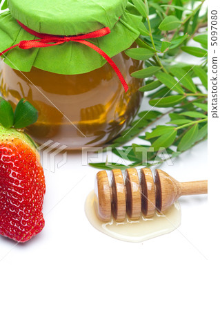 stick to hohey,strawberries  and  jar of honey  isolated on whit 5097080