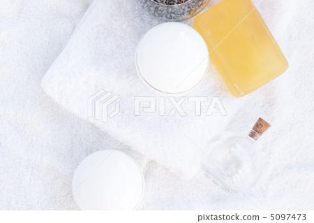 cosmetic containers, bottles, soap and lavender on a white towel 5097473