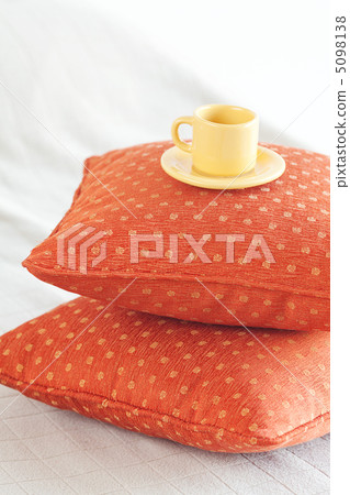cup lying on pillows on the bed cup lying on pillows on the bed 5098138