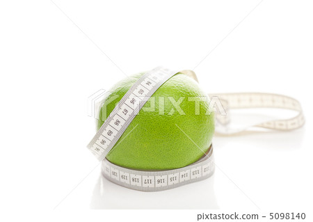 green grapefruit and measure tape isolated on white green grapefruit and measure tape isolated on white 5098140