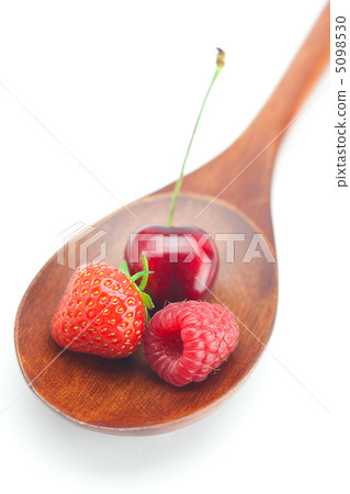 wooden spoon,raspberry, cherries and strawberry  isolated on whi 5098530