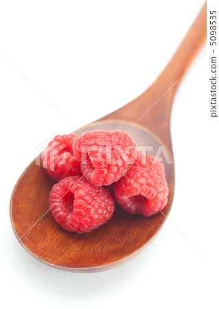 wooden spoon and raspberries isolated on white 5098535