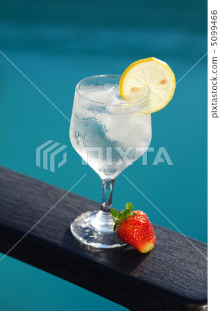 Swimming pool, lounge, a wine glass with ice, lemon and strawber Swimming pool, lounge, a wine glass with ice, lemon and strawber 5099466
