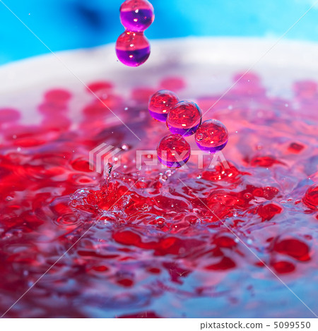 decorative beads in a spray of water on a blue background decorative beads in a spray of water on a blue background 5099550