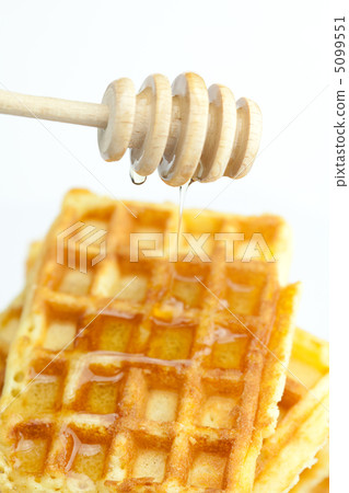 delicious Belgian waffles and stick to honey isolated on white delicious Belgian waffles and stick to honey isolated on white 5099551
