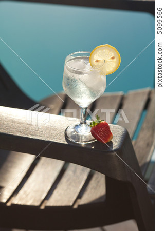 Swimming pool, lounge, a wine glass with ice, lemon and strawber Swimming pool, lounge, a wine glass with ice, lemon and strawber 5099566