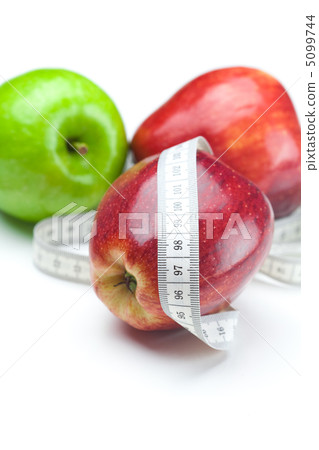 apple and measure tape isolated on white apple and measure tape isolated on white 5099744