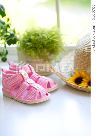Straw hat and sandals at window side 5100703