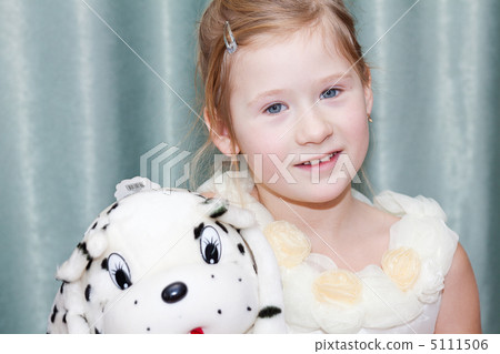 portrait of a beautiful little girl with a toy dog 5111506