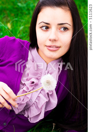 portrait of a beautiful young woman with dandelion portrait of a beautiful young woman with dandelion 5111623