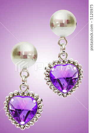 Silver earrings isolated on the white background Silver earrings isolated on the white background 5120975