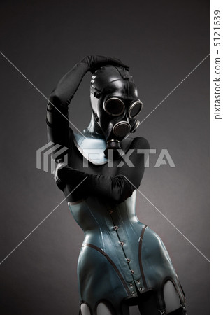 Woman in latex corset and gas mask Woman in latex corset and gas mask 5121639