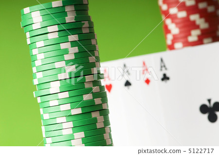 Casino chips and four aces against green background 5122717