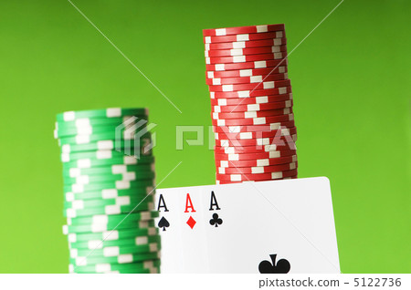 Casino chips and aces against green background Casino chips and aces against green background 5122736