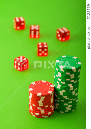 Casino chips and dice against green background Casino chips and dice against green background 5122769