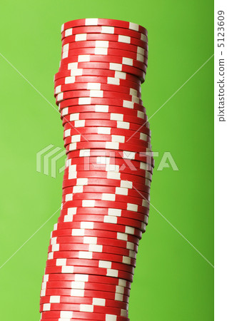 Stack of red casino chips against green background 5123609