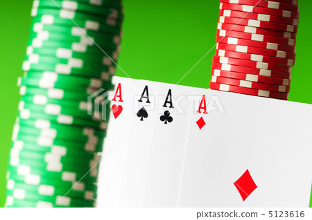 Casino chips and aces against green background Casino chips and aces against green background 5123616