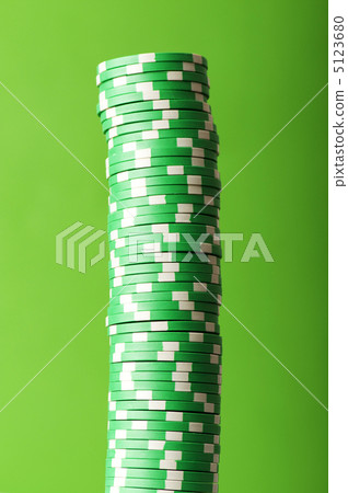 Stack of casino chips against green background 5123680