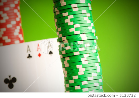 Casino chips and four aces against green background 5123722