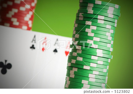 Casino chips and four aces against green background 5123802