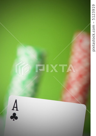 Casino chips and four aces against green background 5123919