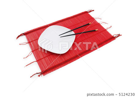 Chopsticks and plate on the bamboo mat 5124230
