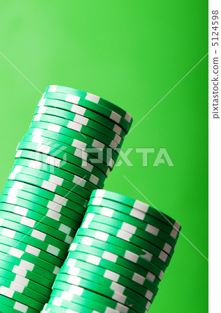 Stack of casino chips against green background 5124598