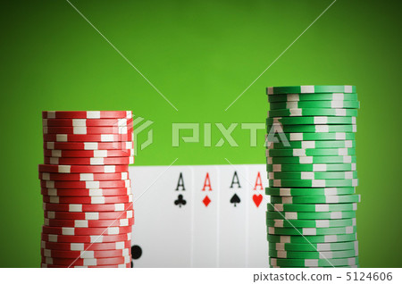 Casino chips and four aces against green background Casino chips and four aces against green background 5124606