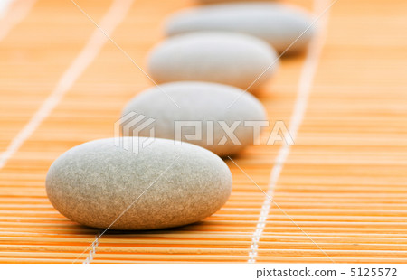 Stack of spa pebbles against blurred background Stack of spa pebbles against blurred background 5125572