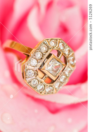 Golden ring against pink rose 5126269