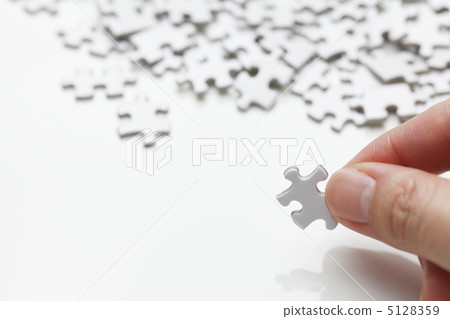 Jigsaw puzzle and hand 5128359
