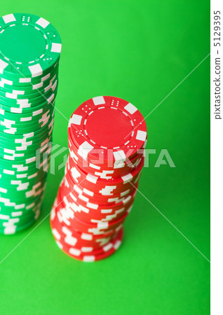 Casino chips and cards against green background Casino chips and cards against green background 5129395