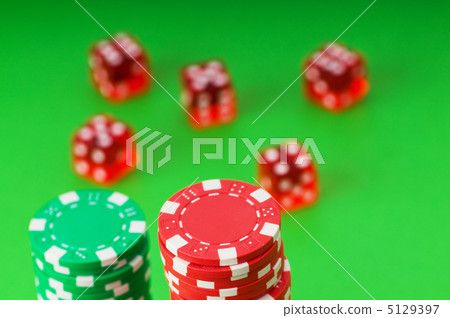 Casino chips and cards against green background 5129397