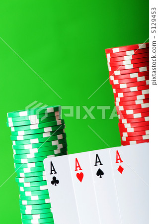 Casino chips and cards against green background 5129453