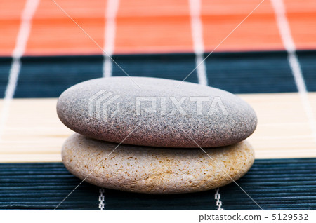 Stack of spa pebbles against blurred background Stack of spa pebbles against blurred background 5129532