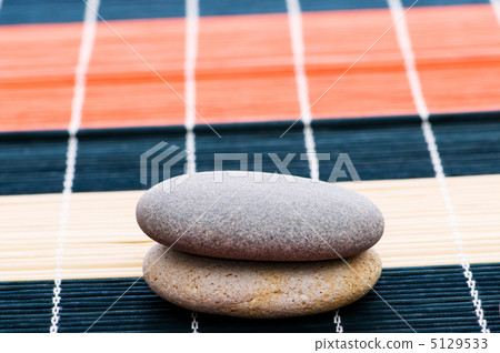 Stack of spa pebbles against blurred background Stack of spa pebbles against blurred background 5129533