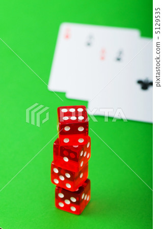 Casino chips and cards against green background Casino chips and cards against green background 5129535