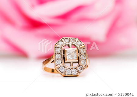 Golden ring and rose at the background Golden ring and rose at the background 5130041