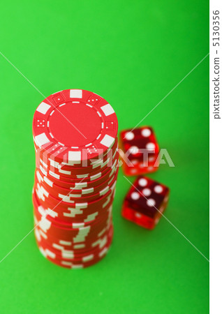 Casino chips and cards against green background 5130356